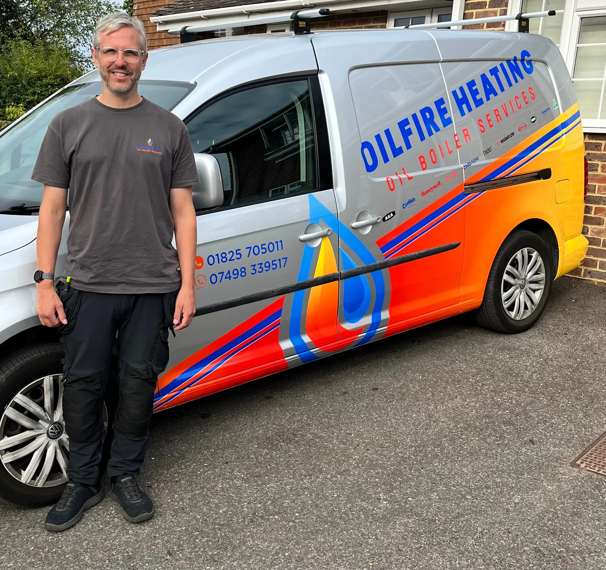 Steve Fretten standing beside the sign-written Oilfire Heating van on a customer's driveway